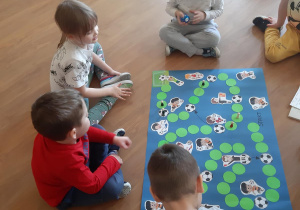 Adam, Witek, Lilka i Miłosz podczas gry w planszówkę.